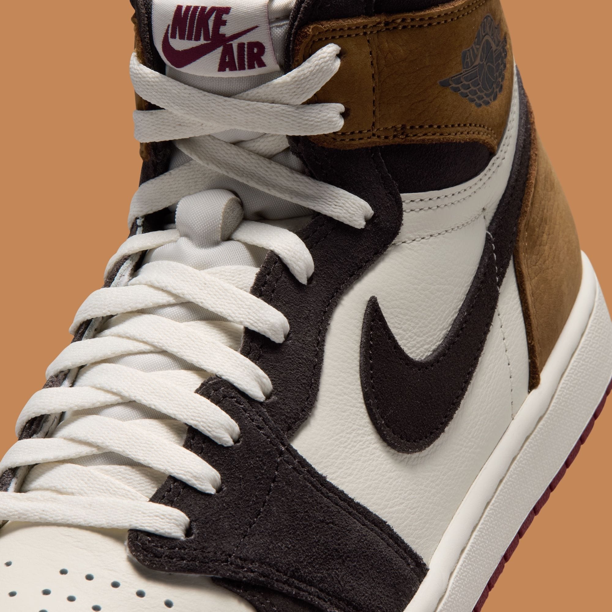 Close-up of the Air Jordan 1 High OG Love Letter toe box, black suede Swoosh and white leather lacing panel