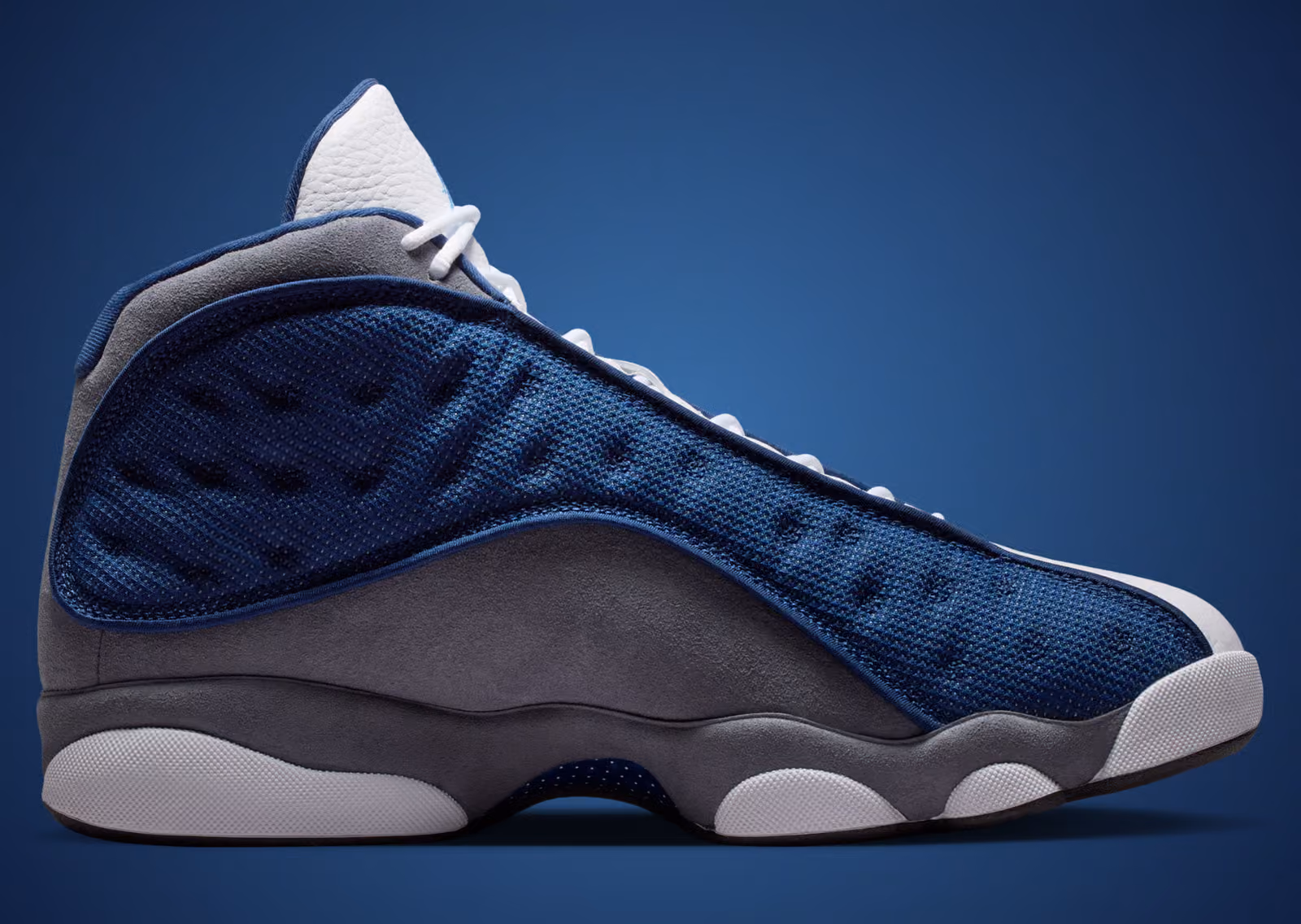 Air Jordan 13 Flint 2026 medial view showing grey suede mudguard