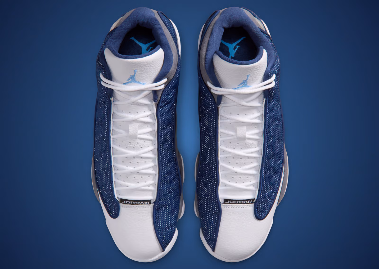 Air Jordan 13 Flint 2026 top-down view of both shoes showing navy Jumpman on tongue