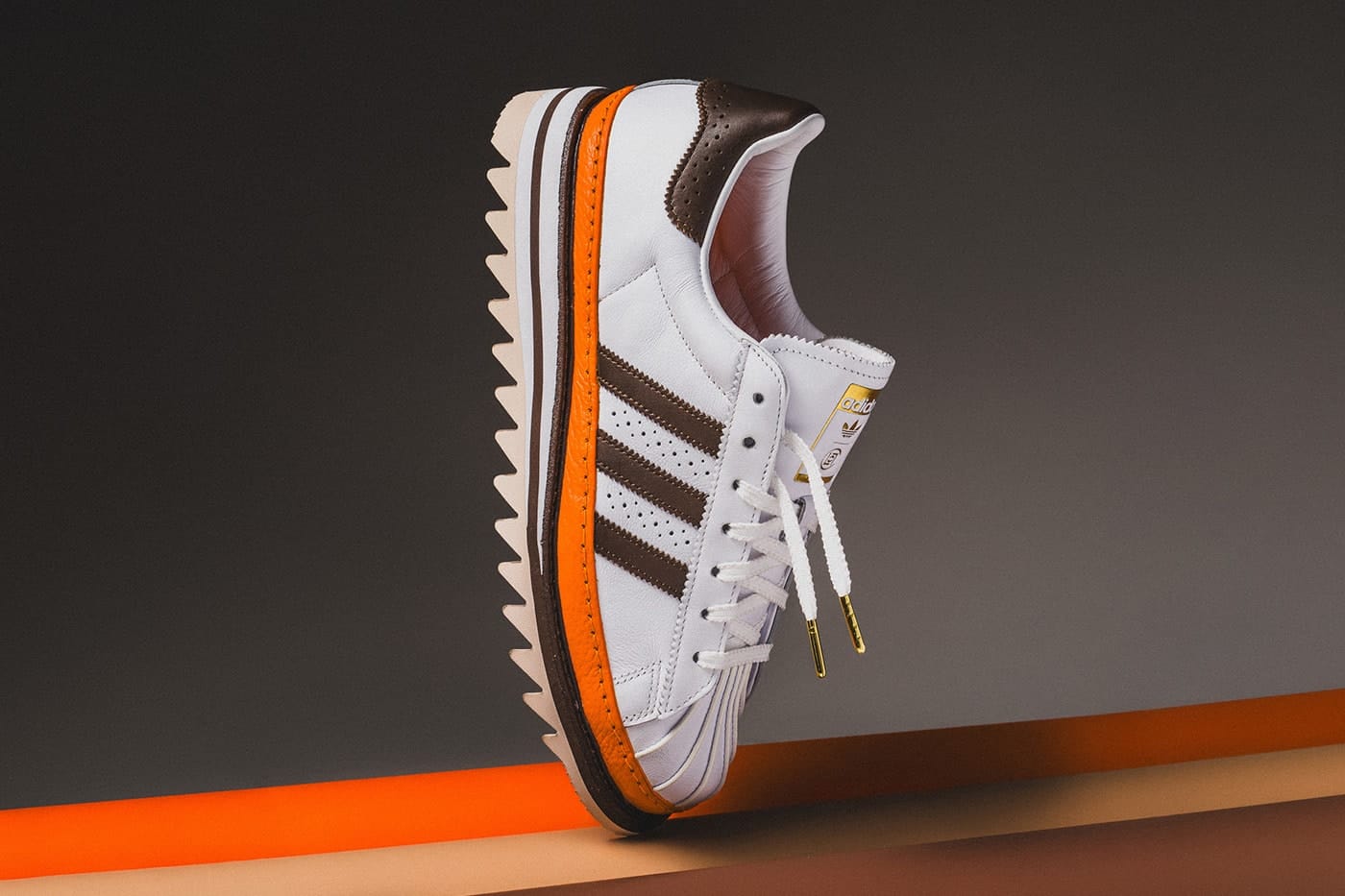 CLOT x adidas Superstar Unity Orange floating lateral profile view