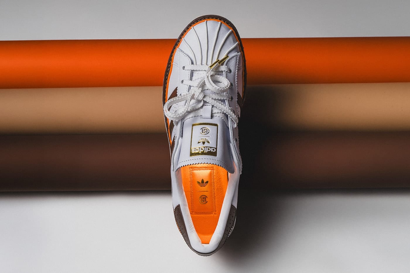 CLOT x adidas Superstar Unity Orange tongue and toe box detail with CLOT medallion