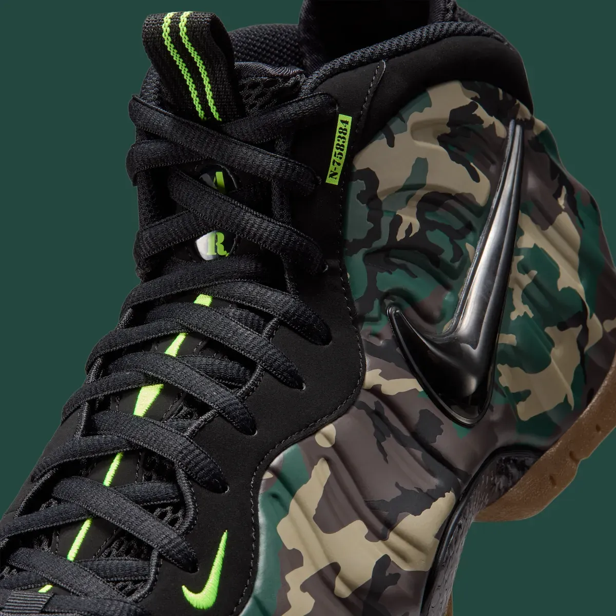 Close-up of the Nike Air Foamposite Pro Green Camo eyestay showing the Volt N-758384 military-style tag