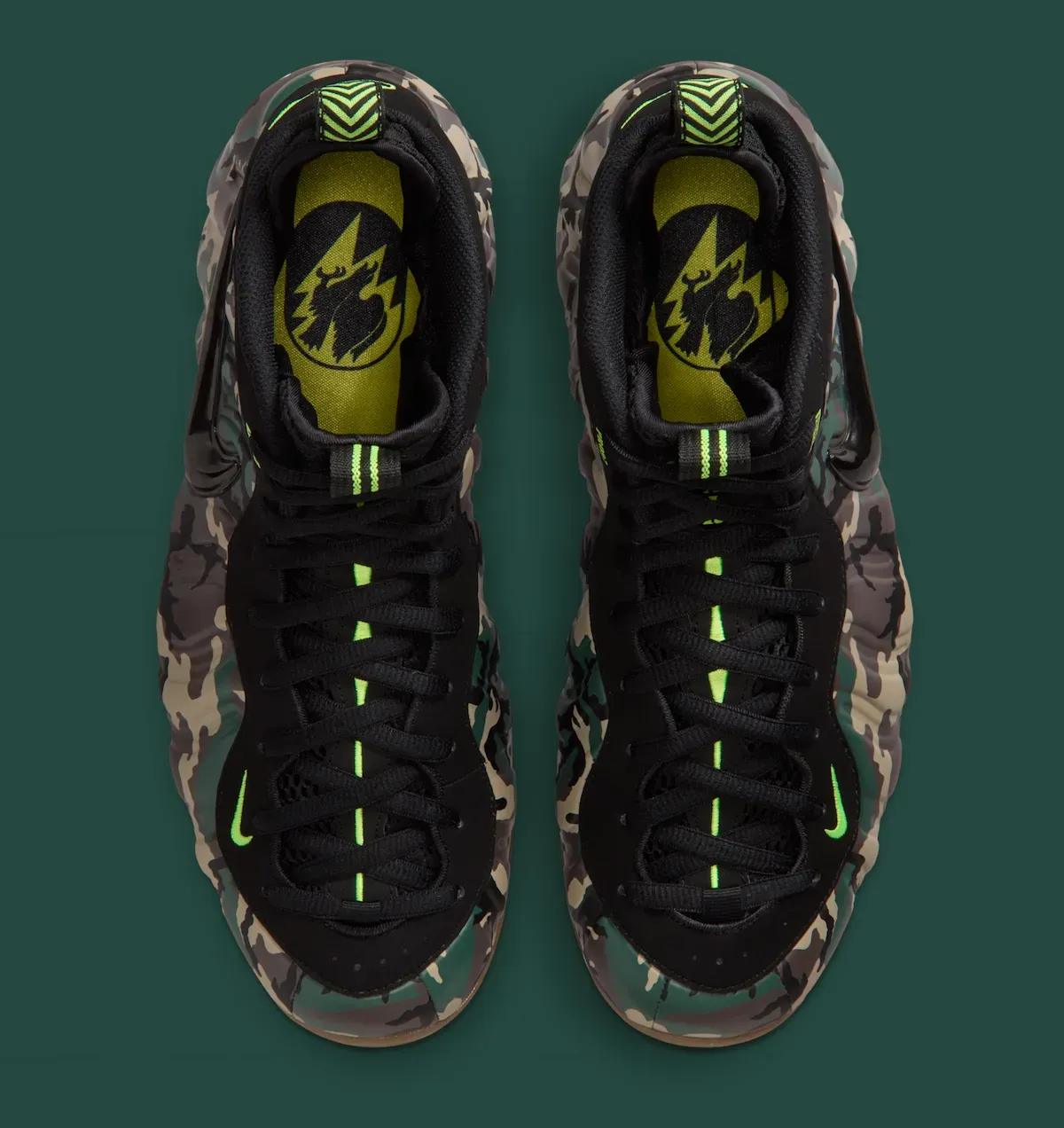 Top-down view of the Nike Air Foamposite Pro Green Camo pair showing the Volt insoles with eagle and lightning graphic
