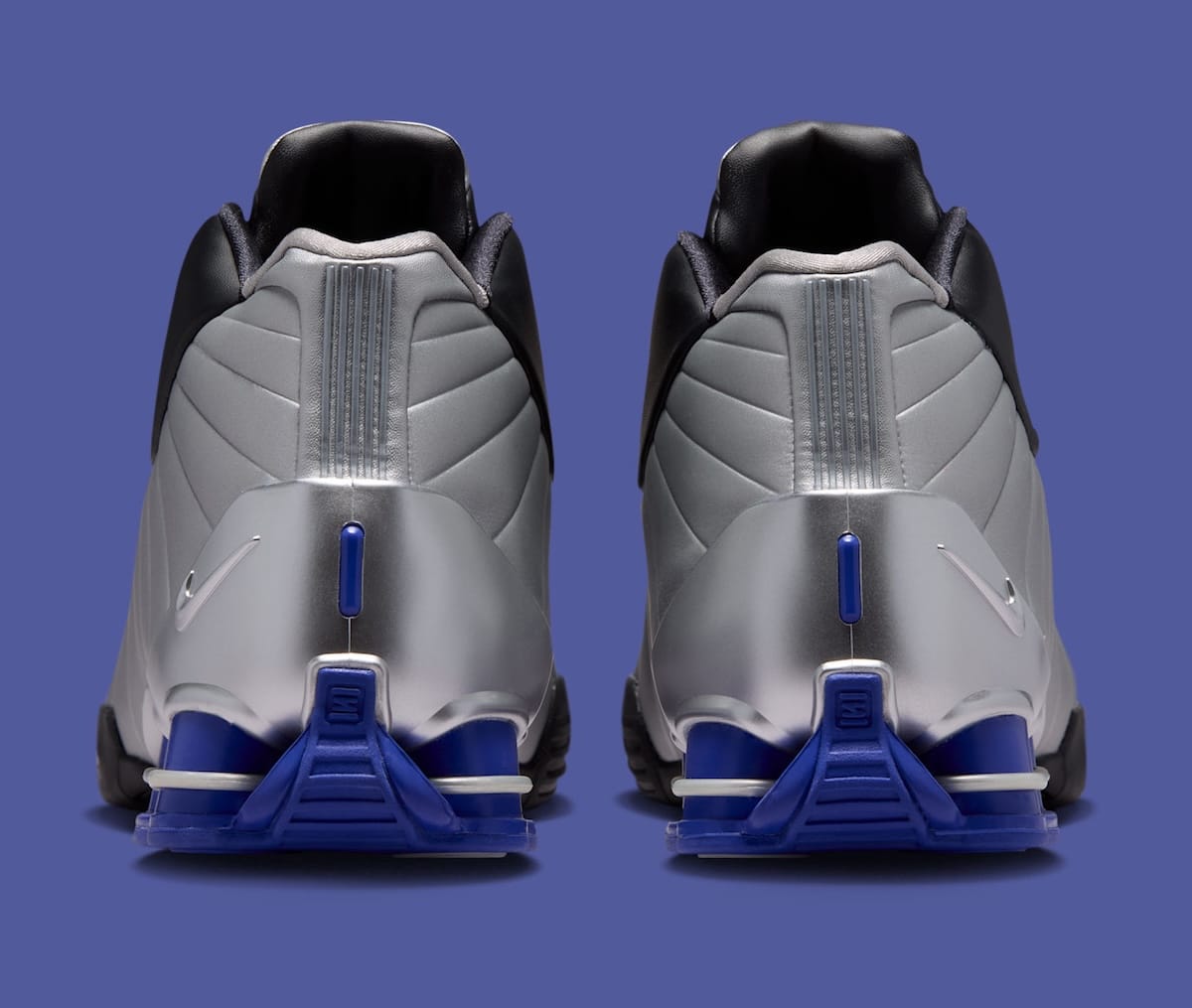 Nike Shox BB4 OG Black/Lapis heel view showing exposed lapis blue Shox columns