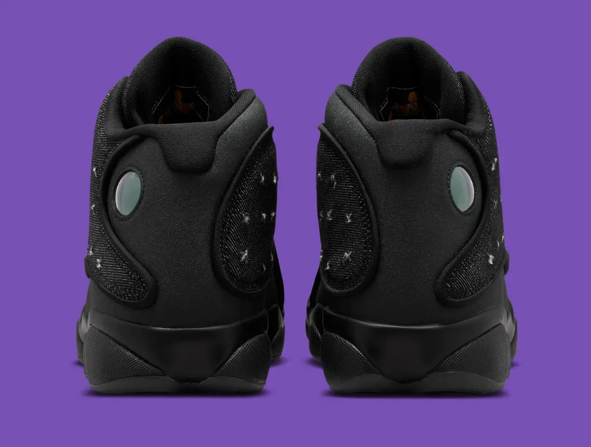 Air Jordan 13 Wings heel view showing the pale green cat-eye hologram on the collar