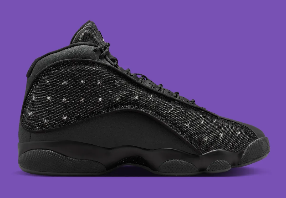 Air Jordan 13 Wings medial view showing black denim twill panel and distressed cross-stitch pattern