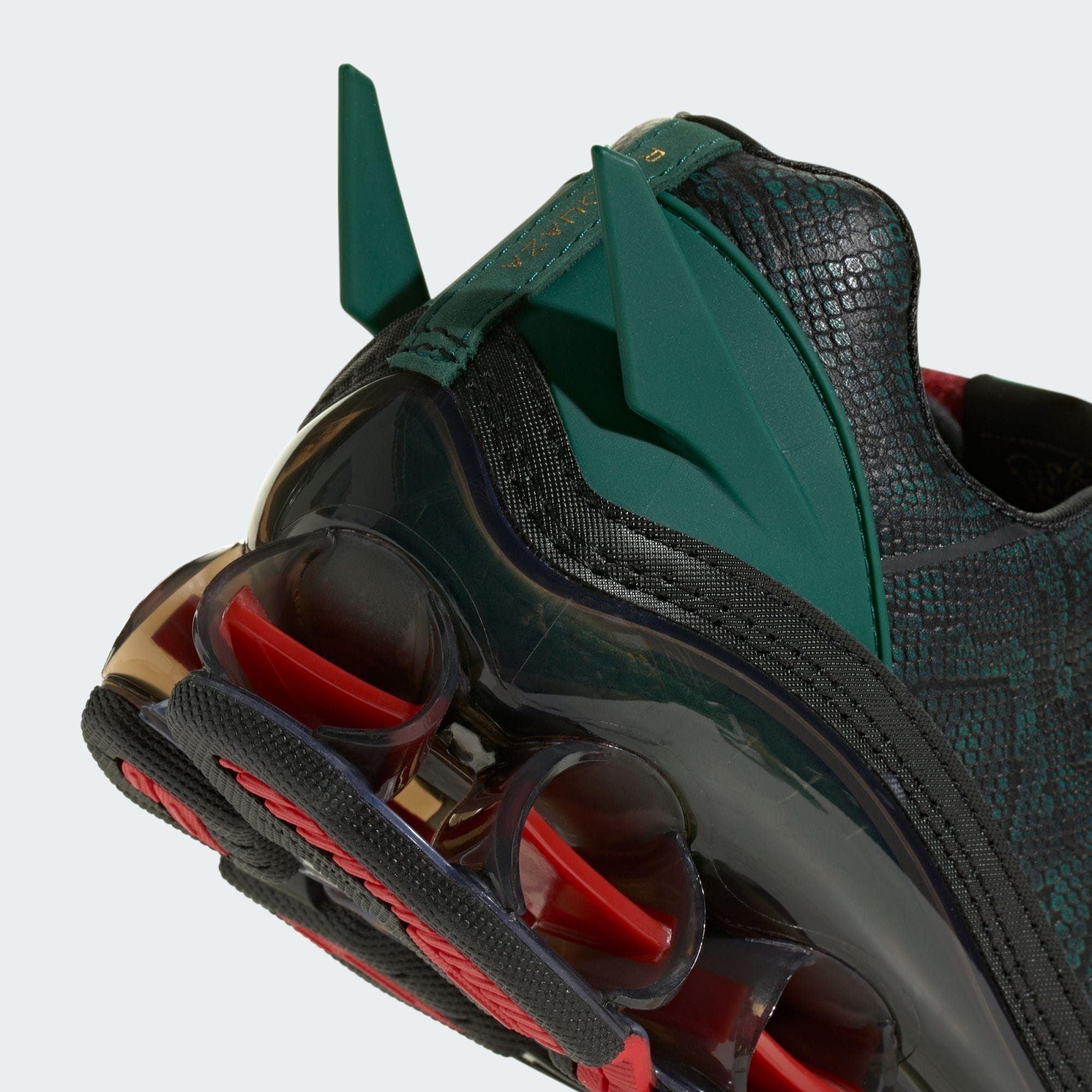 Pokémon x adidas F50 Tunit Mega Rayquaza in green scale-textured material with an oversized lace cover