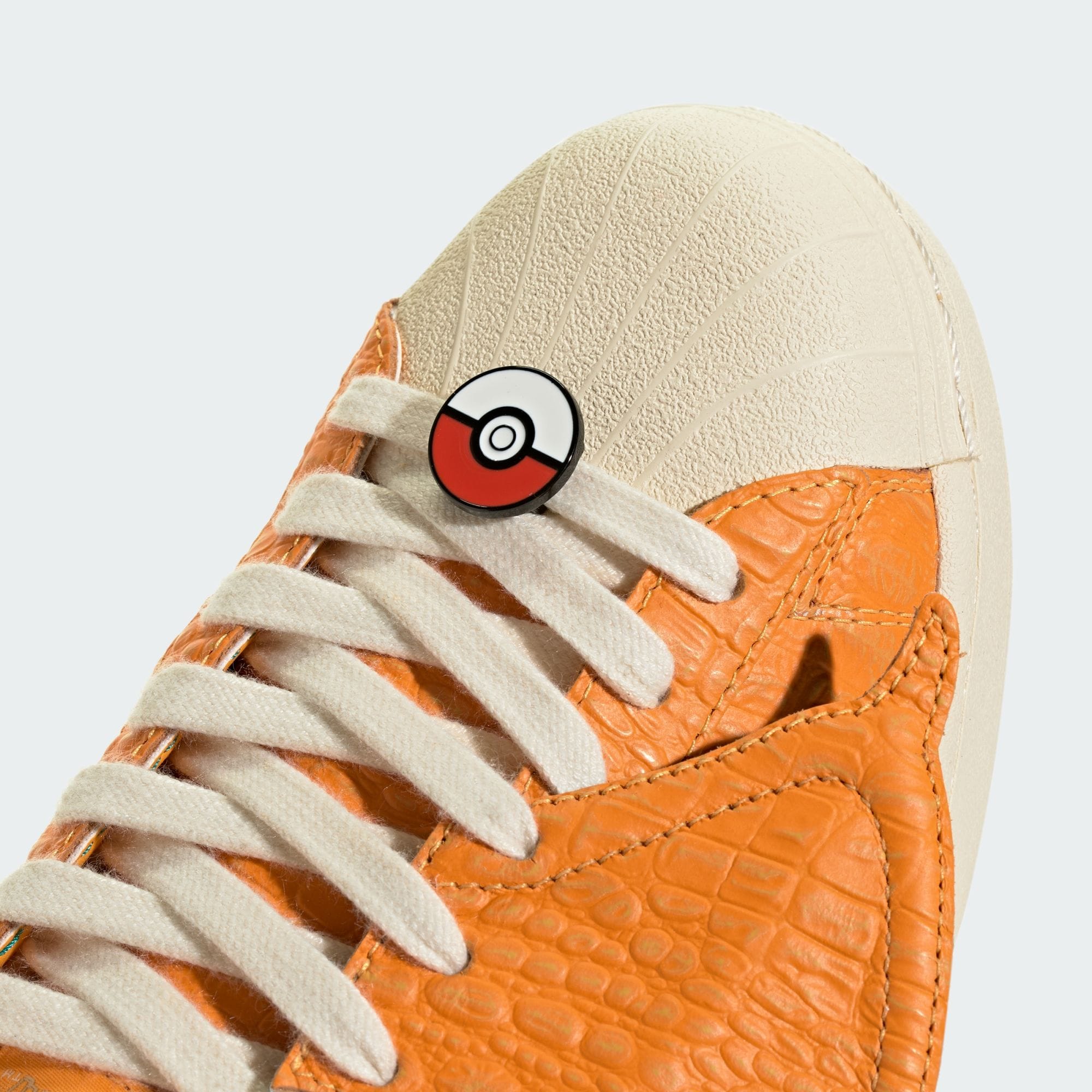Pokémon x adidas Superstar Vintage Charizard in orange and cream with a wing-shaped flap across the eyelets
