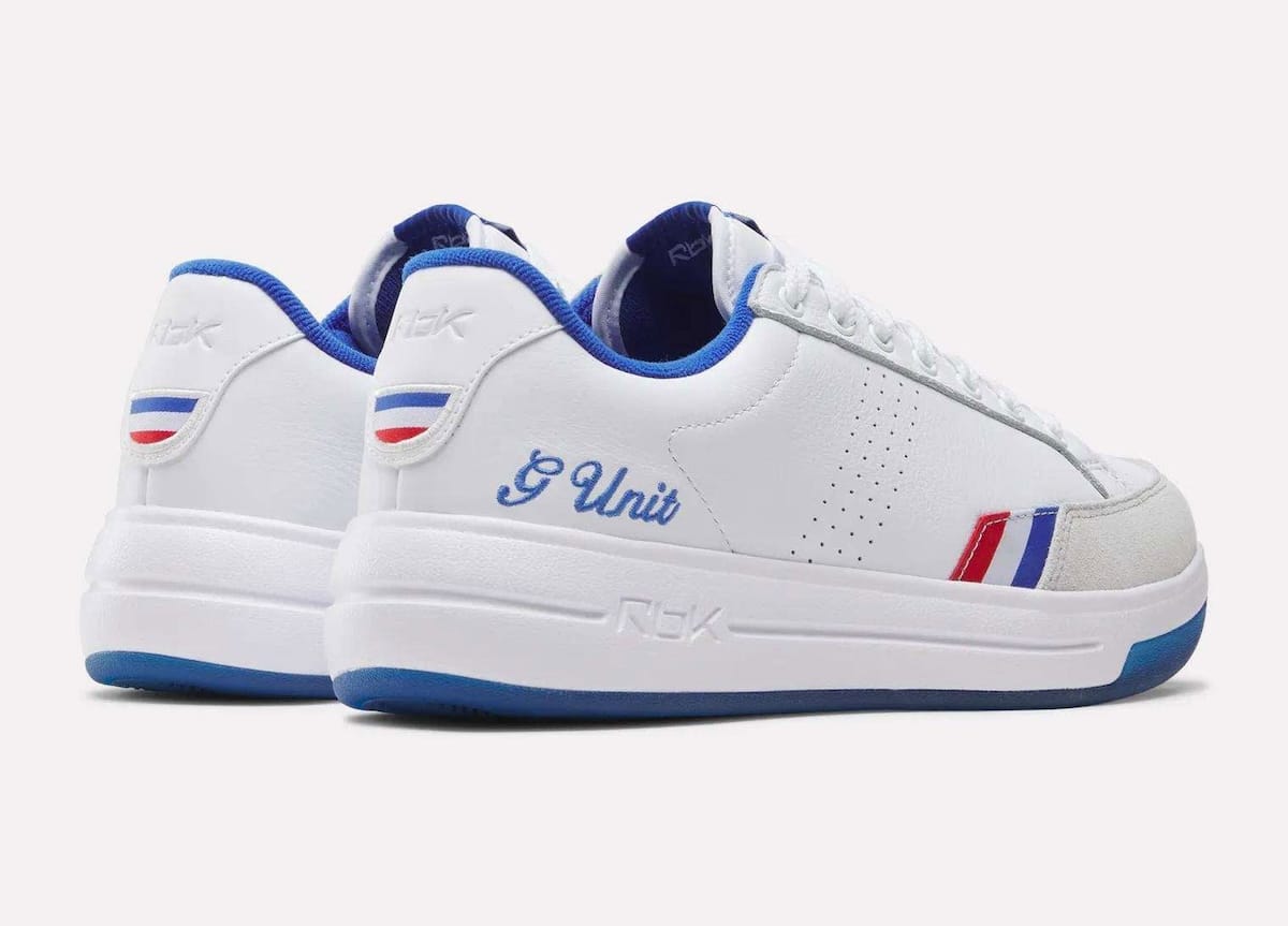 Rear three-quarter view of the Reebok G-Unit G6 showing the royal blue G Unit script at the heel and the tri-color heel tab
