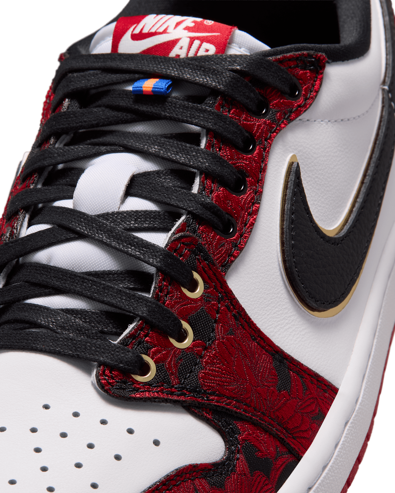 Air Jordan 1 Low OG Garden close-up of the blue and orange lace loop and Metallic Gold Swoosh outline