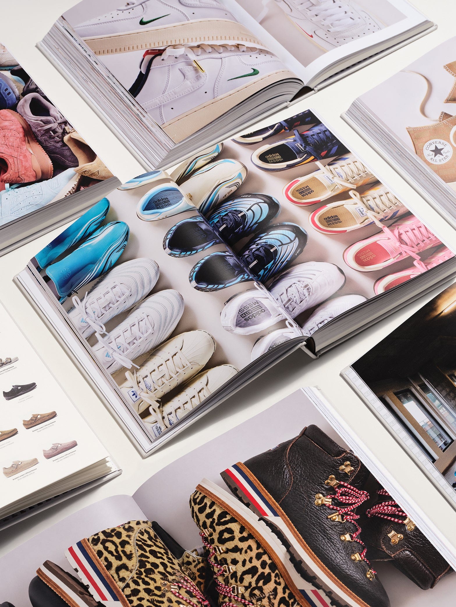 Open copies of Kith: The Footwear Archive showing Nike, Converse and hiker boot collaborations