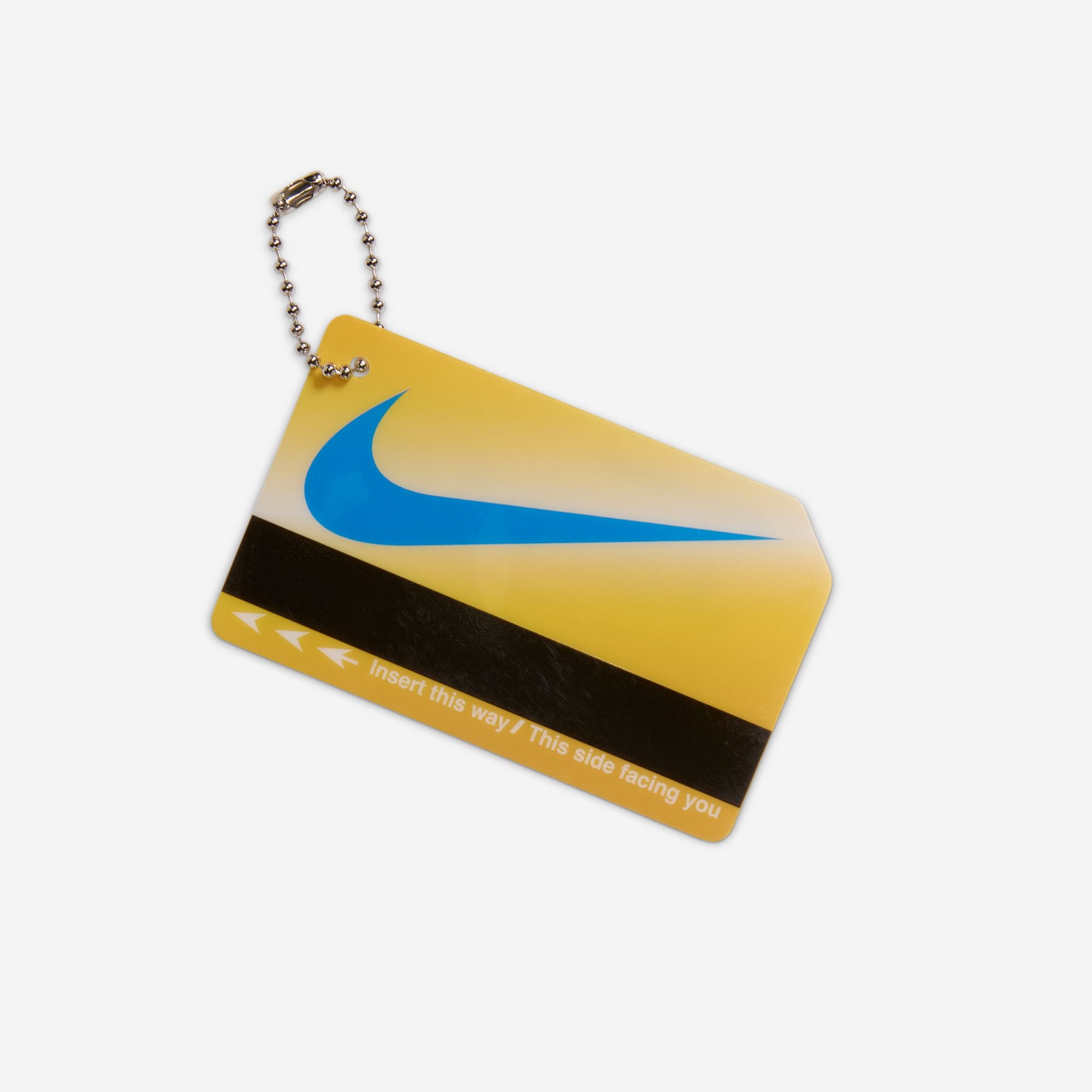 Yellow MetroCard-style hangtag with a blue Nike Swoosh