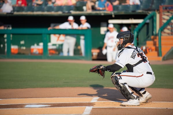 Adley Rutschman in a Baltimore Orioles uniform behind the plate