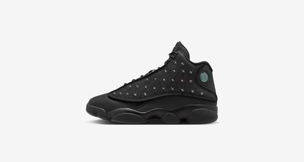 Air Jordan 13 "Wings" IX1872-001 pair in black denim beside its Wings Legacy Graphic special-edition box